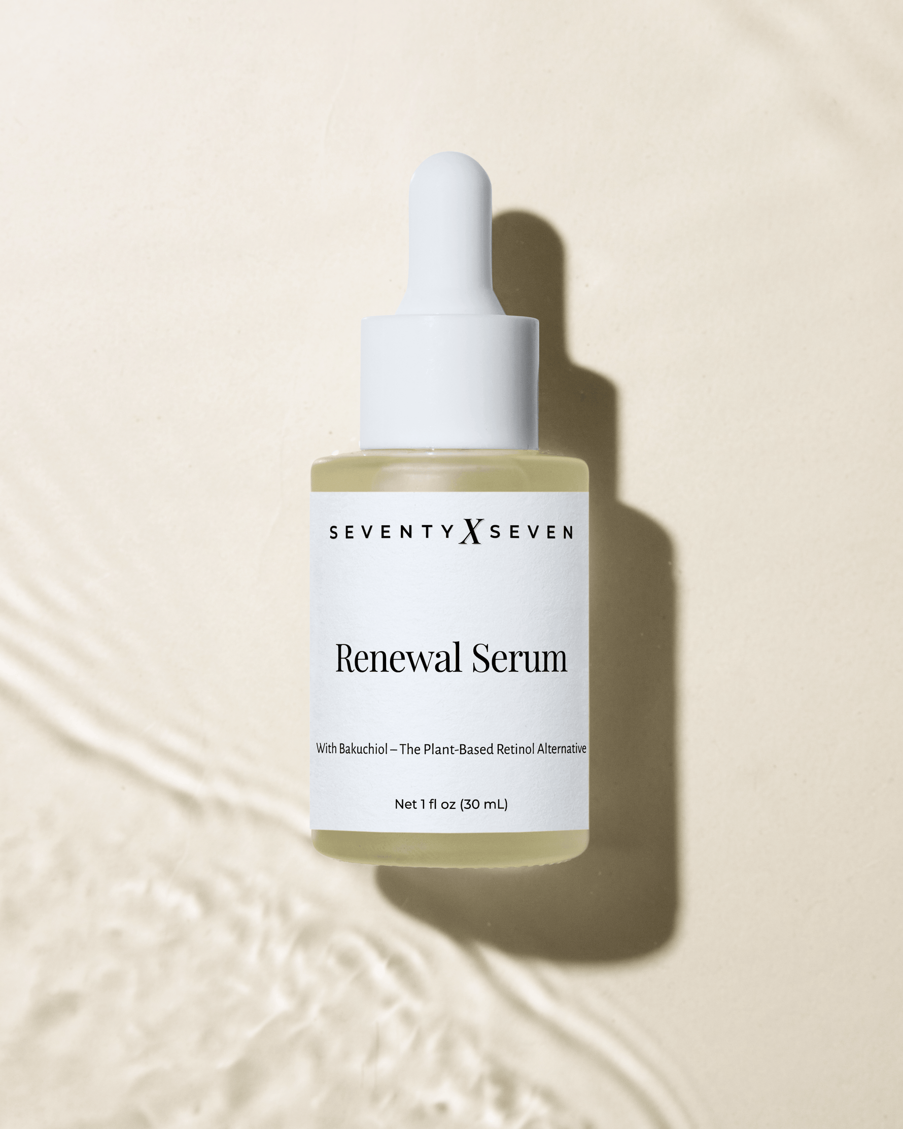 Renewal serum with bakuchiol in a frosted glass dropper bottle on a luxurious beige  textured background