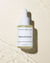 Renewal serum with bakuchiol in a frosted glass dropper bottle on a luxurious beige  textured background